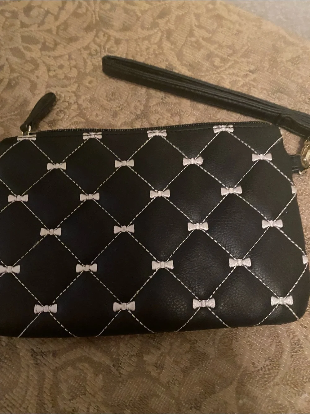 Betsey Johnson Black Quilted Bow-Print Wristlet with Gold Plaque